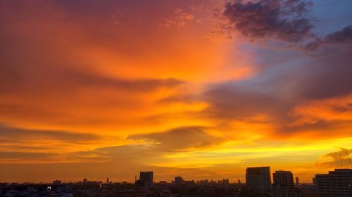 Silhouette buildings against sky during sunset