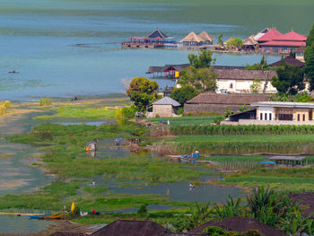 High angle view of houses by lake and buildings