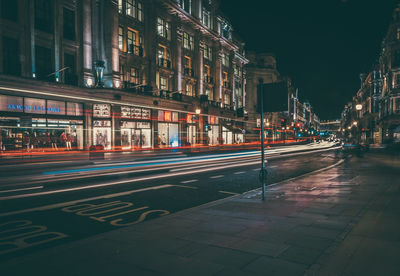 Illuminated city street at night