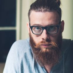 Close-up portrait of bearded man at home