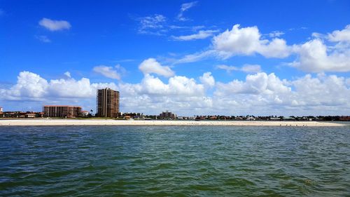 Panoramic view of sea and buildings against sky