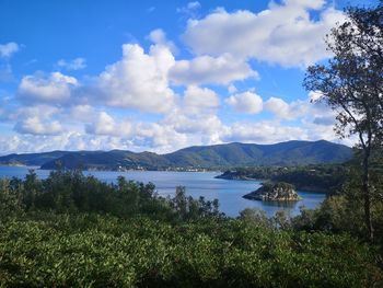 Scenic view of lake and mountains against sky
