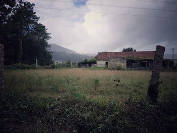 Abandoned building on field against sky