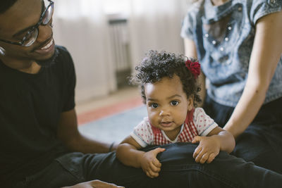 Portrait of baby girl with mother and father at home