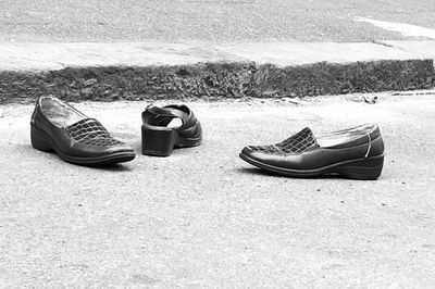 High angle view of abandoned shoes on sand