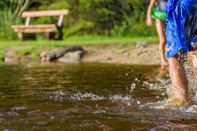 Rear view of woman enjoying in lake