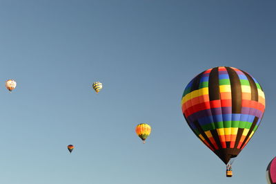 Low angle view of hot air balloons against clear sky
