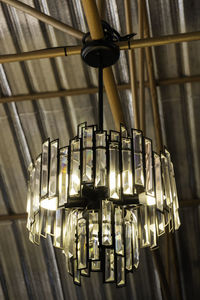 Low angle view of illuminated pendant lights hanging from ceiling