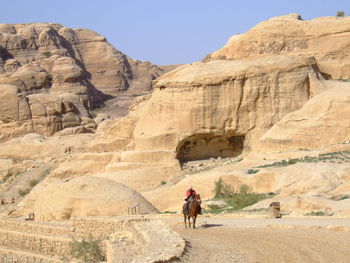 People riding horse in a desert