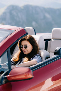 Portrait of woman sitting in car