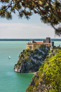 Gulf of trieste. high cliffs between boats, karst rocks and ancient castles. duino. italy