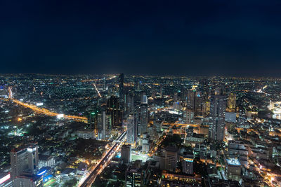 High angle view of illuminated city buildings at night