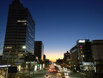 Illuminated city street and buildings at night