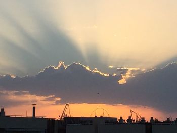 Dramatic sky over city at sunset