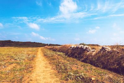 Dirt road along countryside landscape