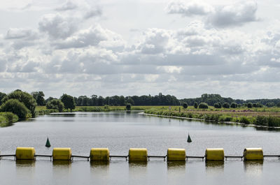 Scenic river with yellow barrier