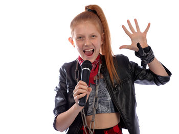 Portrait of smiling girl standing against white background