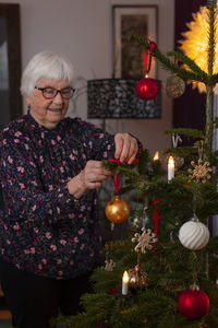 Woman decorating christmas tree