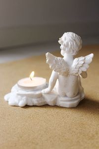 Close-up of burning candle on table