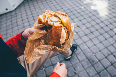 Low section of man holding burger