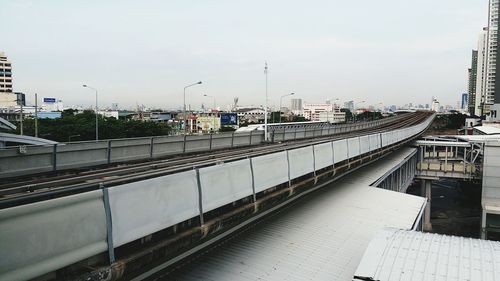 High angle view of railroad tracks in city against sky