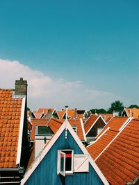 Low angle view of houses against blue sky