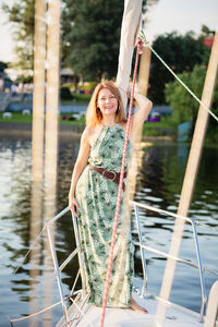 Beautiful woman relaxing on the nose of the yacht at a sunny summer day