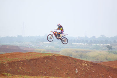 Person paragliding on motorcycle