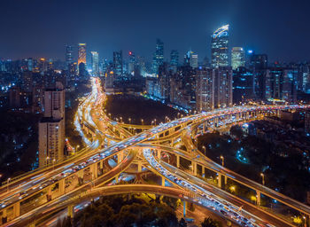 High angle view of illuminated city against sky at night