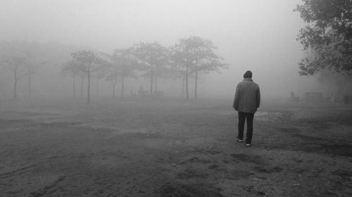 Rear view of man standing on field