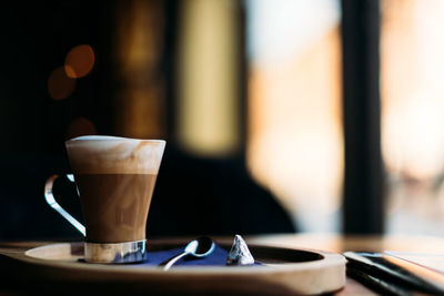 Beautiful setting of cappuccino near window.