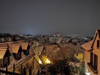 High angle view of illuminated buildings in town against sky