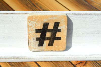 High angle view of hashtag on toy block over wooden table