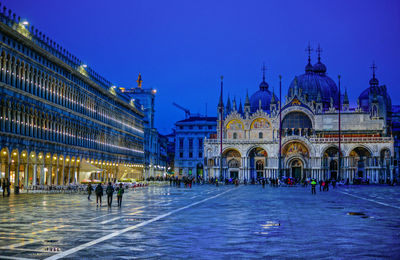 People at st mark cathedral against sky during dusk