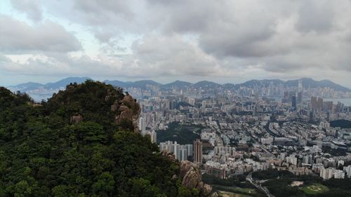 Panoramic view of buildings and trees against sky