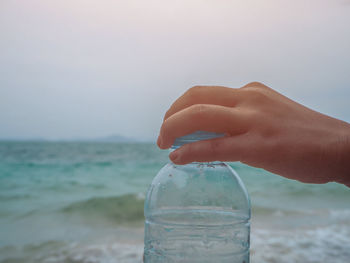 Human hand holding glass of water