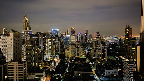 Illuminated cityscape against sky at night