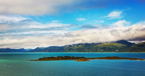 Scenic view of lake against cloudy sky
