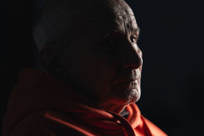 Close-up of young man against black background