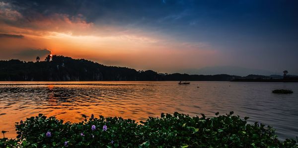 Scenic view of calm sea against dramatic sky