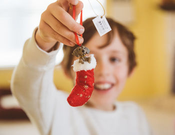 Close-up of boy holding christmas stocking