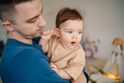 Child yawns in the father's arms