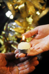 Close-up of man holding candle