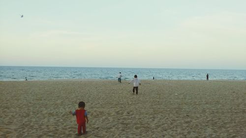 Silhouette of people standing on beach