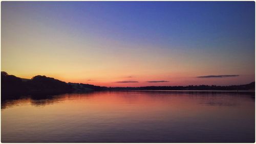 Scenic view of lake at sunset