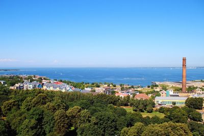 High angle view of trees by sea against clear sky