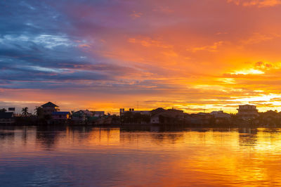 Scenic view of buildings against sky during sunset