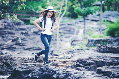 Full length of young woman on rock