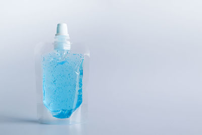 Close-up of blue bottle against white background