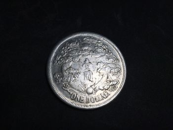 Close-up of coin against black background